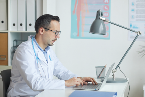 Doctor reading something on a laptop