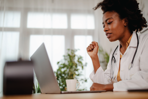 Doctor typing on a laptop